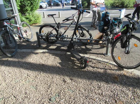 ratelier et poteau devant leclerc les vélos et trottinettes électriques sont attachés par le cadre au ratelier ou poteau, pas comme est prévu le ratelier