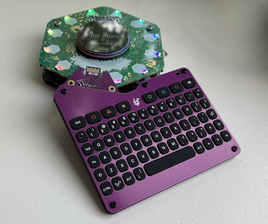 The camp badge in the background, leaning against it is a plug-in keyboard. The keyboard is VERY PURPLE.