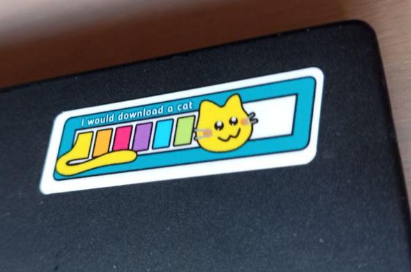 sticker on laptop showing a download bar with a cat head and tail with text 'I would download a cat'