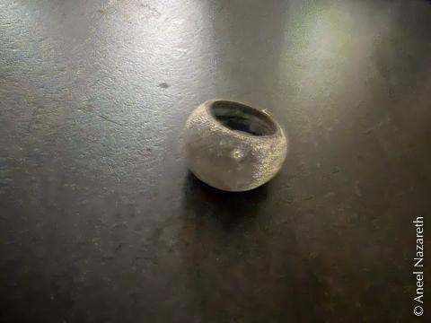 The cast version of the ring has a strange dark cast to the dome and an almost powdery surface