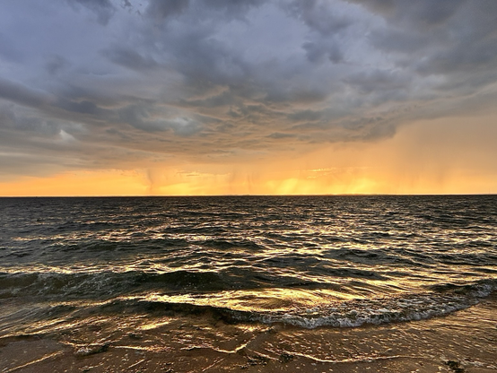 Dramatic clouds over the bay as storms roll through at sunset.