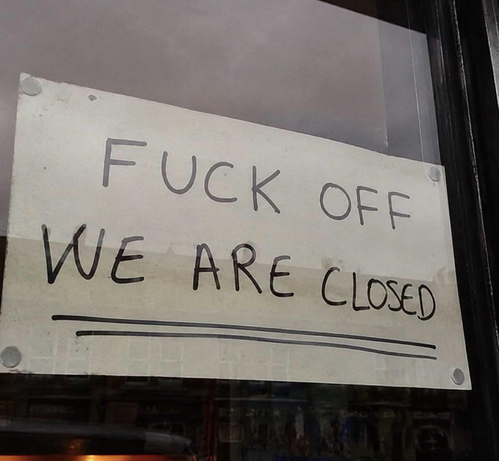Door with a paper note saying FUCK OFF, WE ARE CLOSED
