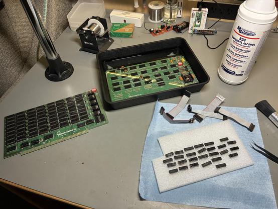 A Vector Graphics Hi Resolution Graphics card, with the chips and interconnects removed, relaxing in a tub of 99% isopropyl alcohol. The accompanying 8k SRAM card sits nearby.