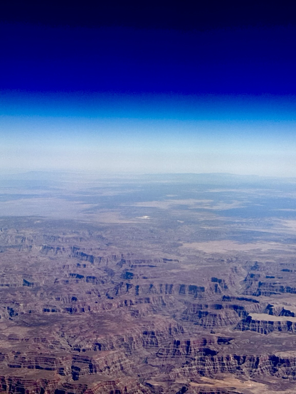 a maze of towering mesas, buttes, and deeply carved canyons, their layered rock formations revealing millions of years of geological history.