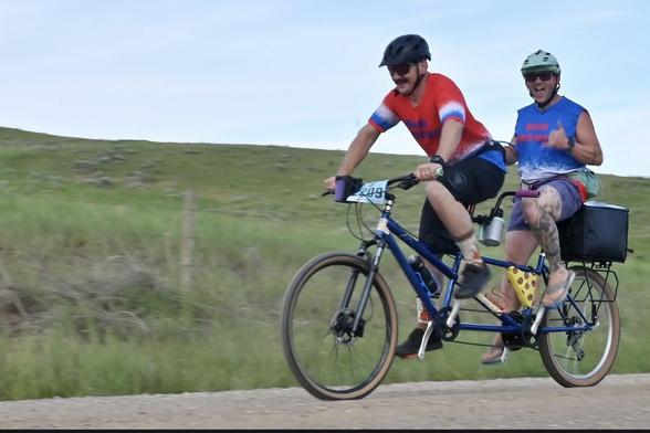 Two outrageously cool cats peddling a gravel tandem bike with a beer and bacon filled cooler on the back. They fed beer and bacon to lesser mortals as they crushed the 100 mile course on a 100 degree day that saw twenty percent of the field drop out before the finish.