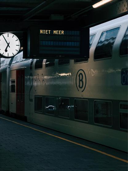 A photo of a departure screen next to a train seen at Brussels Midi. The screen reads “niet meer.”