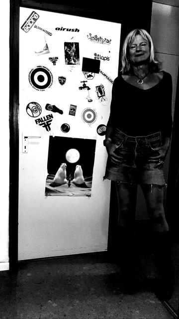 a rather dark version of the same picture. with saturation completely off and the dark even darker. but the door and blonde hair still shine, kind of.