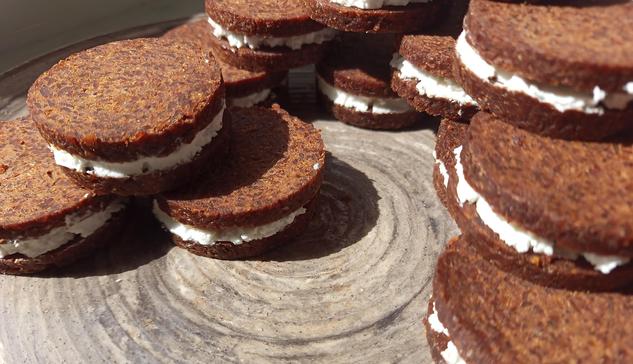 German fancy round bread slices (pumpernickel) with French goat cheese in between
