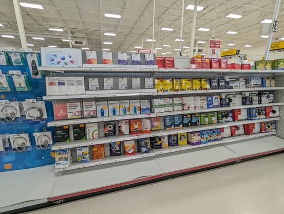 A store aisle with many software boxes, including Adobe Acrobat (lol why), WordPefect (ooo), and... MAVIS BEACON!!!?!? WOW!!!