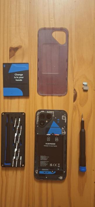 Opened Fairphone with screwdriver next to it