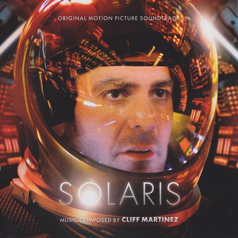 George Clooney looking intently out of a spacesuit helmet.