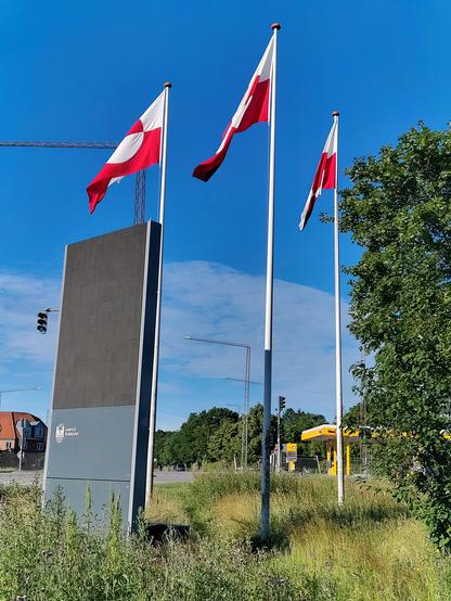 Three Greenlandic flags waiving in the wind somewhere in Aarhus.