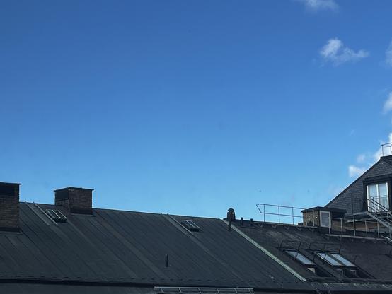 Stockholm skyline, blue sky and some cloud shreds, at the moment of summer solstice 2026, 10:24CET in Stockholm.