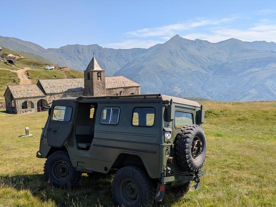 A 1968 Volvo L3315 parked on a grassy mountain pass between Switzerland and Italy