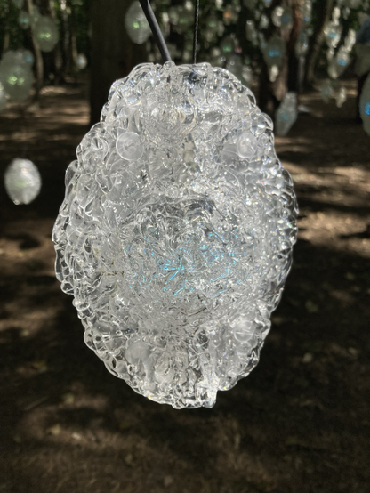 Glass chrystal with blueish shine against dark background