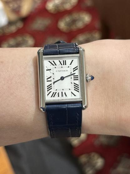 Wrist shot of a Cartier Tank in stainless steel.
