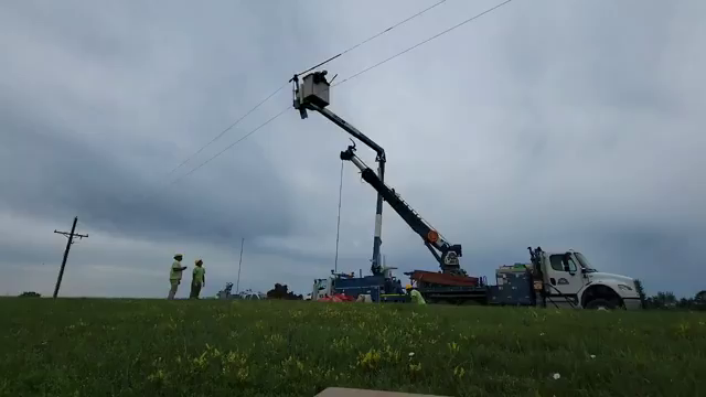 Time-lapse video of a crew raising a power pole. First the pole goes in the ground, then the power lines are attached to insulators, then the conduit to a below-ground cable gets attached, along with other equipment. Finally, a barrel transformer is mounted to the pole and connected to the cable in the conduit.