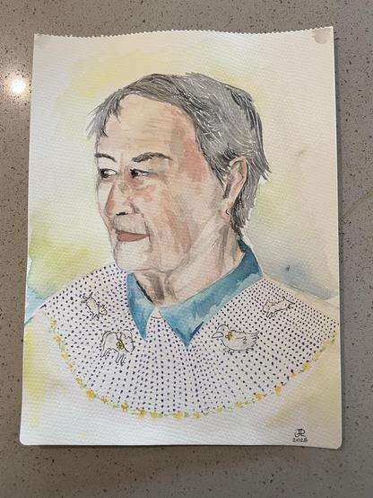 Water color side profile portrait of an elderly woman. She has short salt and pepper hair and a slight smile. Wearing a blue collared short poking out of a polka dot sweater with farm animals along the top (two lambs, a pony, and a duck)