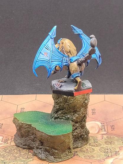 The second rear shot, from the opposite side, shows off the other wing, which looks much the same, including the Lyran Commonwealth logo on the outermost panel, bronzed gauntlet upraised in defiance, but also visible from this angle is a pair of braids running down from the left ear along the manticore's neck.