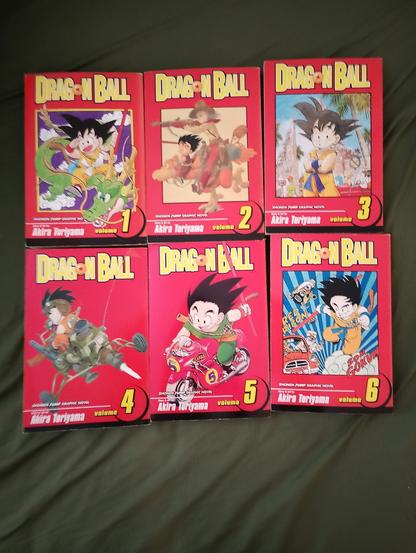 Six books with vibrant red covers and varying artworks by Akira Toriyama