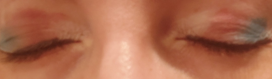 Light eyeshadow in the colours of the trans flag across two closed eyes.