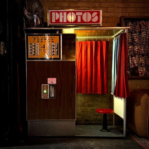 Vintage photo booth illuminating an otherwise dark space