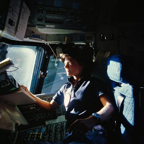 Sally Ride on the flight deck of the Space Shuttle Challenger during the STS-41-G mission