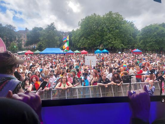 Looking out from a stage at a big queer crowd.