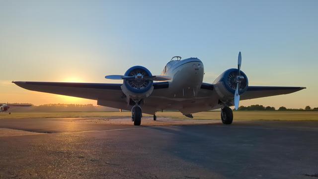 Vintage twin-engine aircraft in front of sunset!