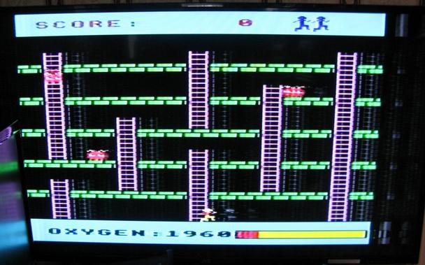 Acornsoft Monsters - a simple platform game with red monsters running around various levels with vertical purple ladders.  Our player is standing at the bottom of the middle level in the starting position.  There's a score/lives etc