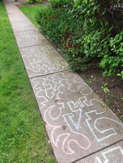Chalk line art on yard sidewalk.