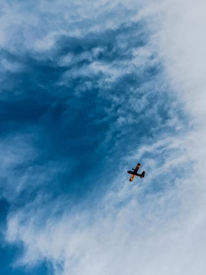 un canadair dans le ciel vu de dessous, le ciel est bleu