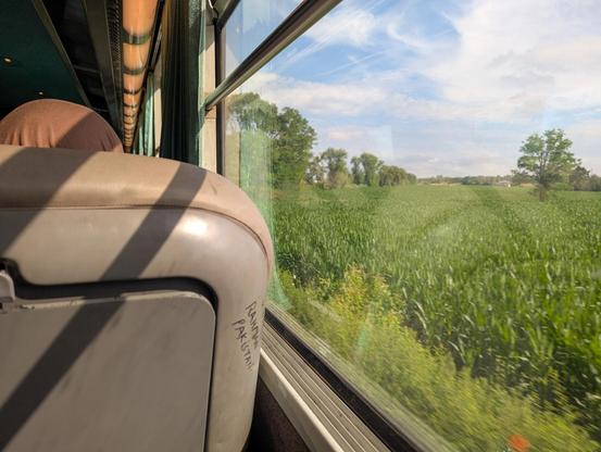 View out of the window of a Corail carriage onto the plains of Alsace.
