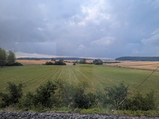 Empty agricultural landscape west of the Voges. Grey clouds in the sky.