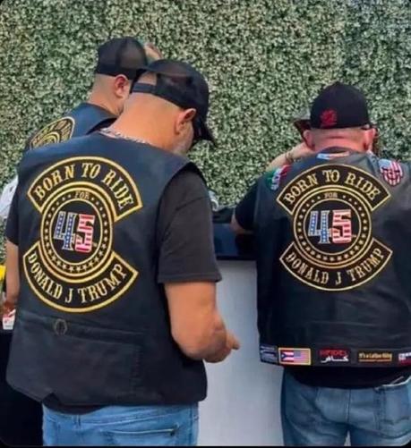 A bunch of white cis-het male douchebags wearing biker jackets with "Born to ride ******for****** 45 Donald J. Trump" on the back.

From the POV of the cameraperson, the logos read more like: "Born to Ride Donald J. Trump".