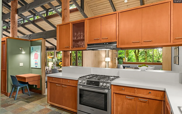 that tall cabinet there over the stove is openable from both sides because this house was designed for living in