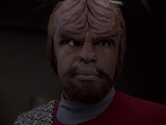 A shot from Star Trek DS9 showing a close-up of Worf talking with Sisko (who is off-camera). They are on the Defiant, which is docked at DS9. From E418