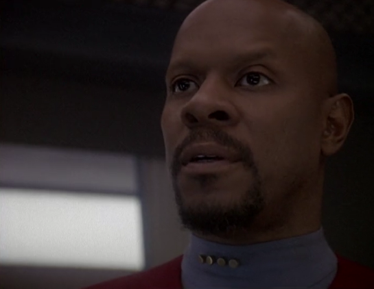 A shot from Star Trek DS9 showing a close-up of Sisko talking with Worf (who is off-camera). They are on the Defiant, which is docked at DS9. From E418