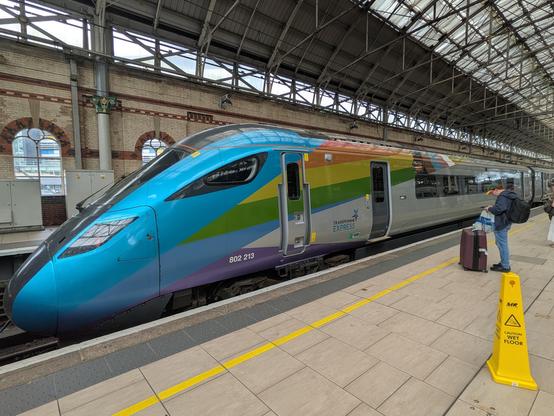 The front nose of a BR Class 802 TPE service at Platform 2, Manchester Piccadilly.
The light blue nose goes back to a rainbow flag "swoosh" going from the middle height to the top of the side.