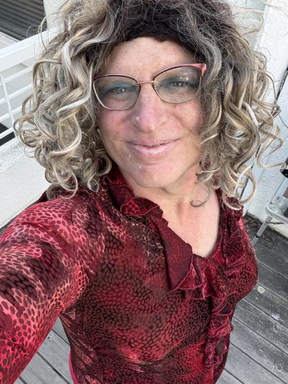 Me wearing a burned velvet blouse in various shades of red with a flowy collar