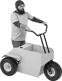 Bearded man in a beanie on a three-wheeled standup electric scooter thing