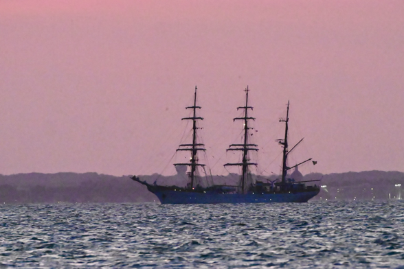 Romanian tall ship with a pink sunset on the Chesapeake bay. Annapolis in the background
