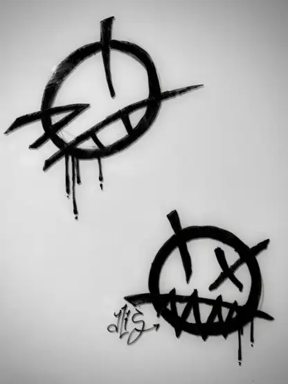 Two edgy-looking smiley faces scribbled on a whiteboard. One looks like it's winking, the other has one eye crossed out and jagged teeth. Both look like the linework is slightly dripping.