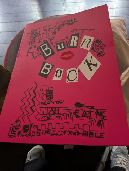 The theatre programme for Mean Girls is called Burn Book and is bright pink with black doodles on it.