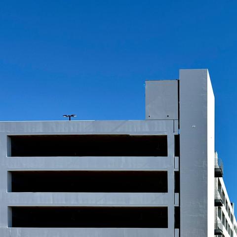 White parking garage against a bright blue sky