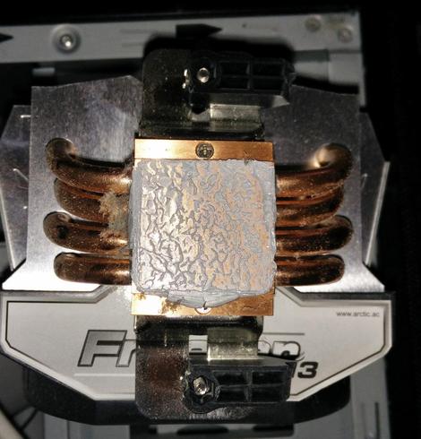 A heatsink and fan that should have been firmly attached to the CPU in the previous pic; it's a big heavy thing with cooling pipes...and a couple of plastic remains.