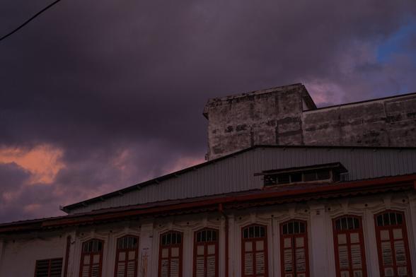A building and a purple and blue sky.