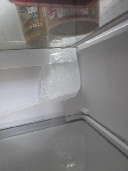 A large lump of ice that has formed in a refrigerator