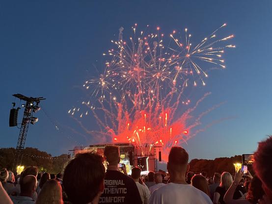 A huge display of red fireworks going off behind the stage.
