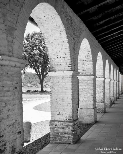 Title: Arches

A line of whitewashed brick arches receding into the distance. In Black and White

Mission San Antonio de Padua, California

June 21, 2026